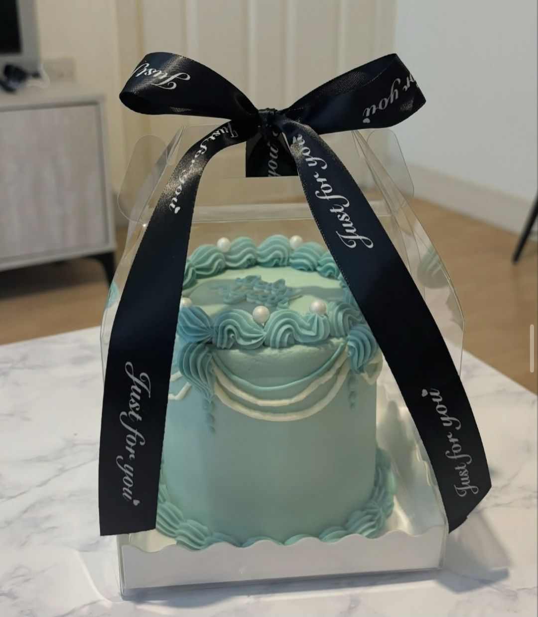 Teal vintage bento with white garlands, pearls and “Baby Dylan” on top (photo 1 of 2)