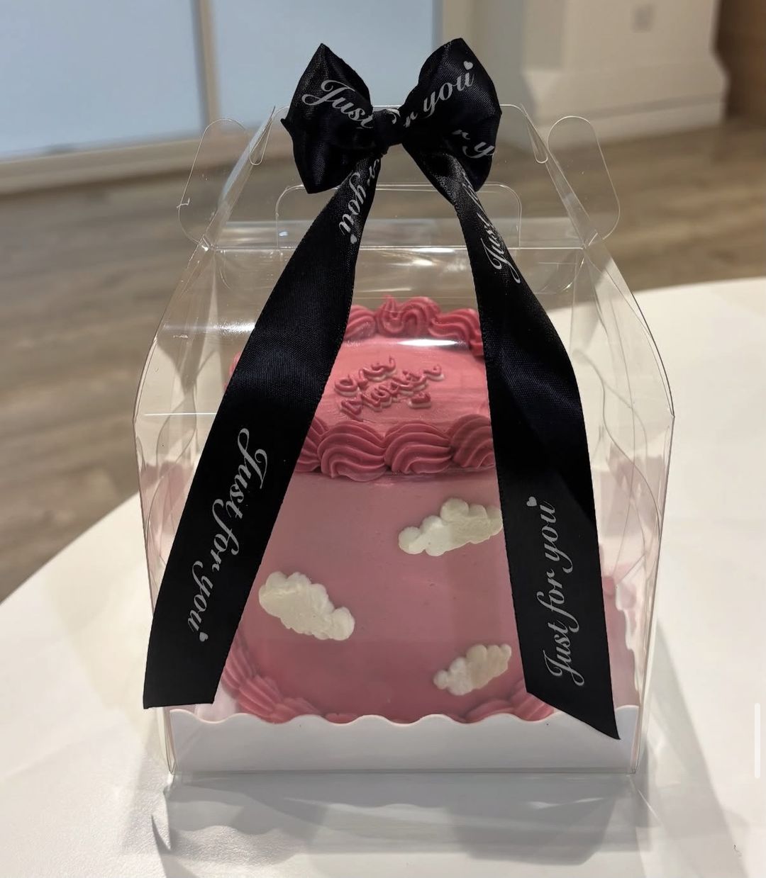 Raspberry-pink bento cake with piped clouds and “One month” on top (photo 1 of 3)