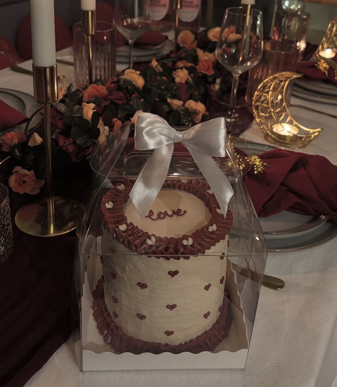Cream bento cake with burgundy ruffles, tiny piped hearts and “love” on top, tied with a white bow (photo 2 of 2)
