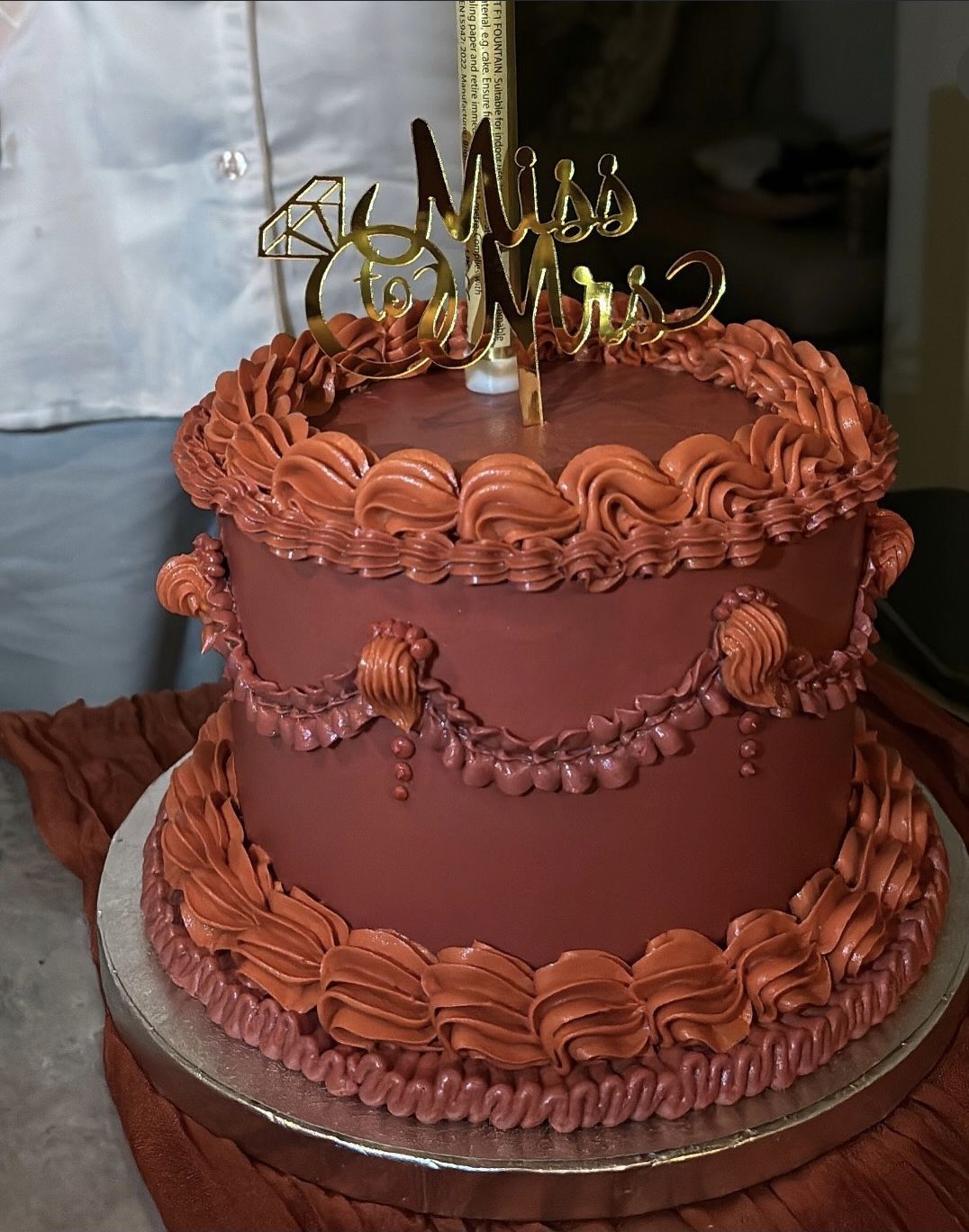 Terracotta vintage cake with swags and ruffles and a gold “Miss to Mrs” topper (photo 1 of 2)