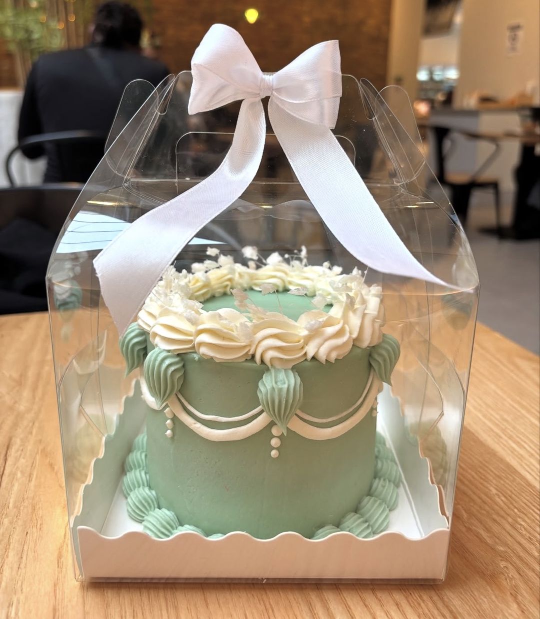 Sage green vintage bento with cream piping and pearl drops, tied with a white satin bow (photo 2 of 2)